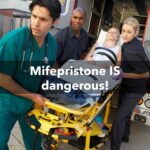 Paramedics and doctor unloading patient from ambulance